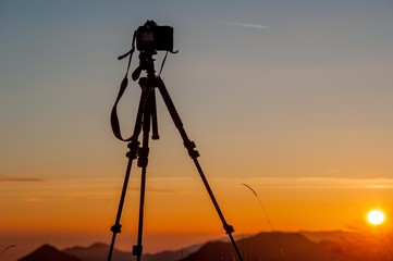 camera mounted on a tripod to photograph the sunset