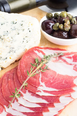cured meats, olives, cheese and red wine