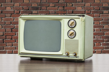 Green Vintage Television with Brick Wall