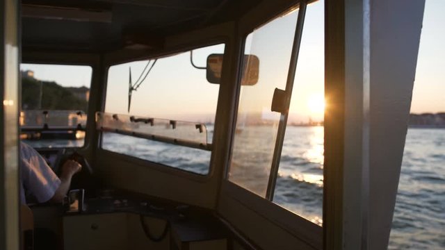 Captain switching lever, man driving river vessel, water transportation services