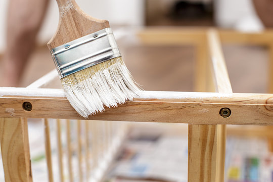 Man Painting Wood Furniture With A Brush And Paints, Close-up