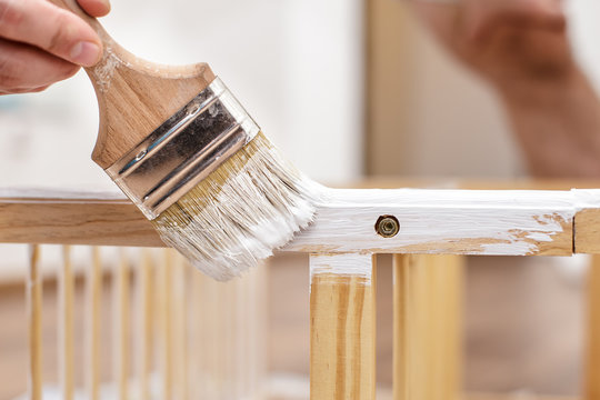 Man Painting Wood Furniture With A Brush And Paints, Close-up