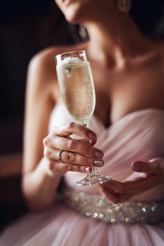 Close-up portrait of a beautiful young elegant  woman with a glass of champagne