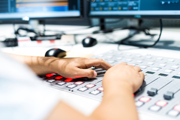 young man dj works in modern broadcast studio