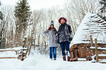 Winter weekend, couple in love having fun on snow in snowfall weather closeup