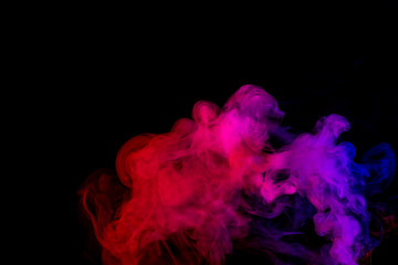 Abstract smoke Weipa. Personal vaporizers fragrant steam. The concept of alternative non-nicotine smoking. Purple pink smoke on a black background. E-cigarette. Evaporator. Taking Close-up. Vaping.