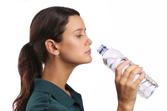 Woman drinking water, isolated against white background