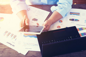 Businessmen looking at turnover on a desk.
