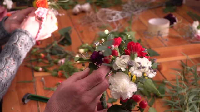Master class of a florist making flower ring.