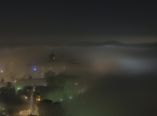 Bergamo - Old city (Cittˆ Alta). One of the beautiful city in Italy. Lombardia. The fog rises from the plains and wrap all the old city by creating lighting effects.