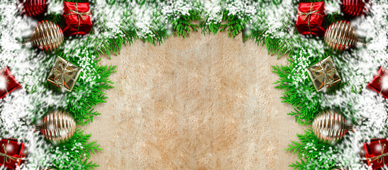 Obraz na płótnie Canvas Wooden background with snow and ball box green leaves for texts display