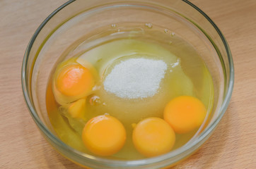 egg and sugar in a glass container, cooking