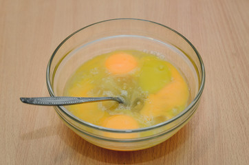 beaten eggs in a glass container, cooking