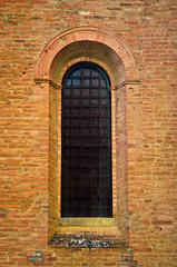 Fototapeta na wymiar Window of Romanesque brick church