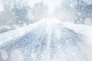 Zelfklevend Fotobehang Countryside road during snow storm © Africa Studio