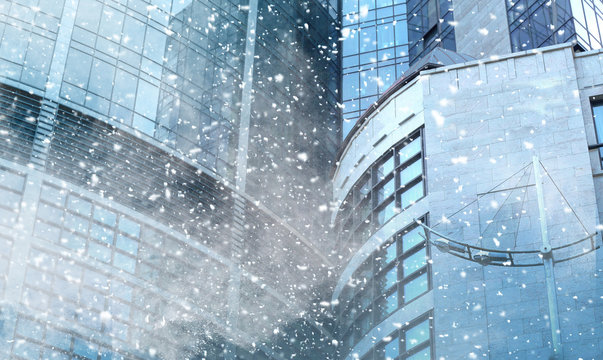 Snow storm and skyscraper on background