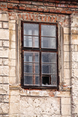 Fototapeta na wymiar Old broken window of the cracked house