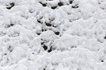 Snow on the wooden fence as a backdrop