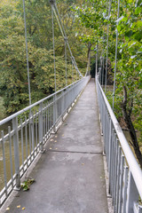 Vanishing suspension footbridge with rails to church of Agia Paraskevi Tempi. Pieria, Greece.
