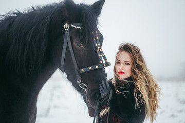a girl with a horse in a field in winter