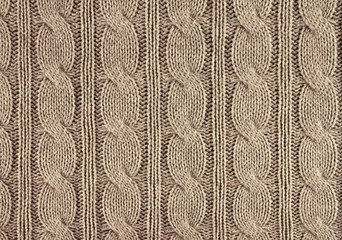 beige knitted textured background with a pattern closeup