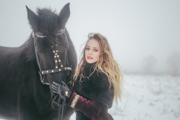 Obraz premium a girl with a horse in a field in winter