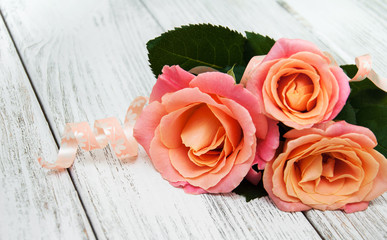 Pink roses on a wooden background