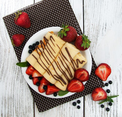 crepes with strawberries and chocolate sauce