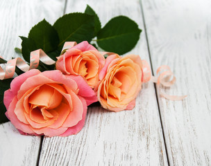 Pink roses on a wooden background