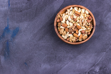 Assorted nuts in a wooden bowl