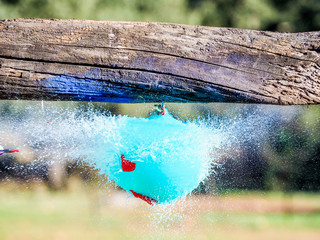 Balloons exploding when hit by an arrow. Closeup hi-speed shot.