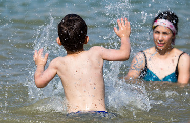 Mom and son swimming in the lake