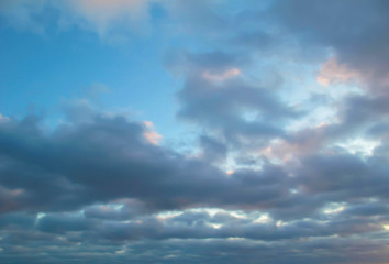 Naklejka na ściany i meble Cumulus sunset clouds with sun setting down