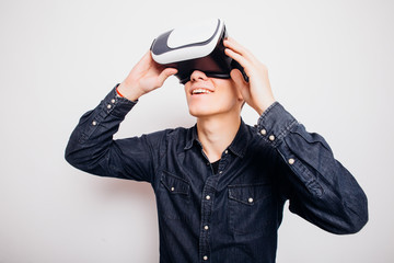 Attractive man with virtual reality glasses isolated on a white background