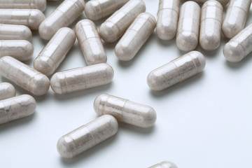 White medicine capsules probiotic powder inside. Close up. High resolution product.  Health care concept