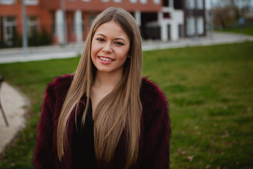 Obraz premium Pretty blonde girl with fur coat