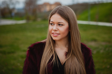 Obraz premium Pretty blonde girl with fur coat