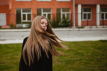 Naklejka premium Pretty blonde girl with a beautiful long
