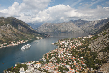 Fototapeta na wymiar Beautiful Aerial view of the city, mountains and the ship in the Bay of Kotor