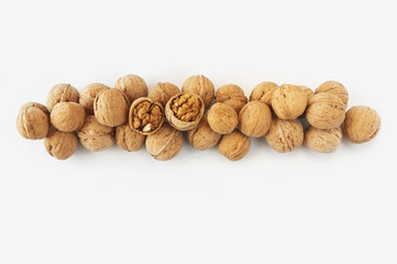 Walnuts on white background. Walnuts at border of image with copy space for text. Top view. Vegetarian or healthy eating.