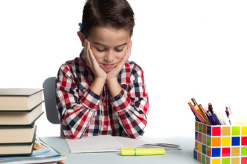 Schoolboy struggling to do math calculations. Boy doing homework