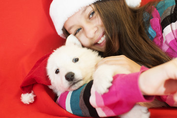 child and puppy in Christmas hat