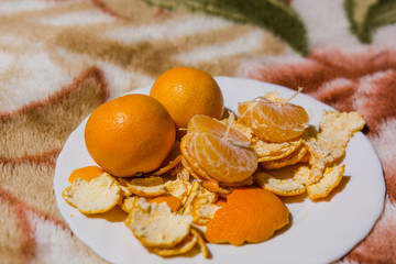 Tangerines lie on a white dish