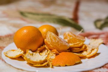 Tangerines lie on a white dish