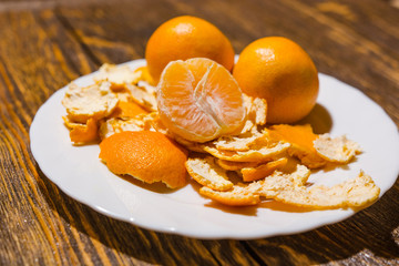 Tangerines lie on a white dish