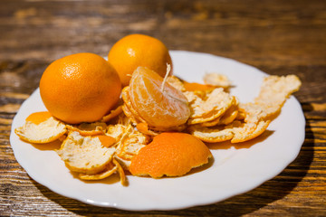 Tangerines lie on a white dish