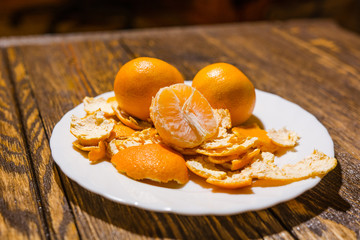 Tangerines lie on a white dish