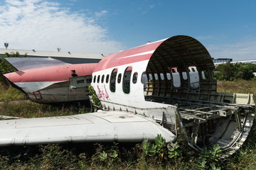 Plane fuselage wreckage sitting on the ground