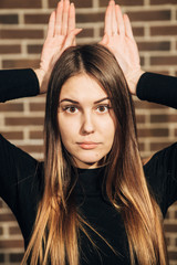 Fototapeta premium beautiful brunette depicts the rabbit