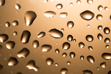Water drops on the glass at sunset